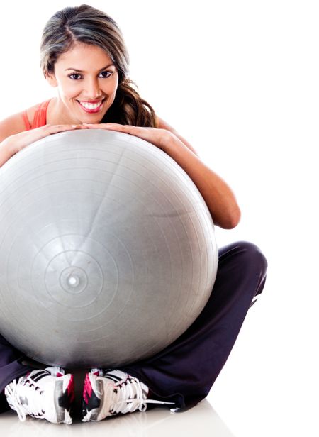 Athletic woman with a Pilates ball - isolated over a white background