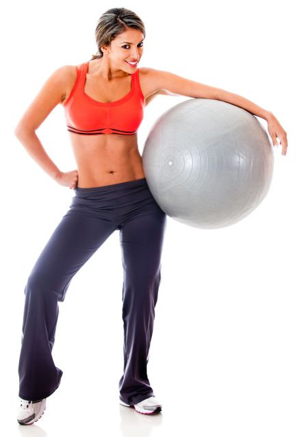 Athletic woman with a Pilates ball - isolated over a white background