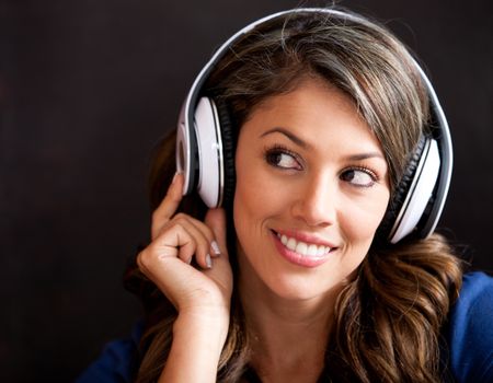 Woman portrait listening to music with headphones