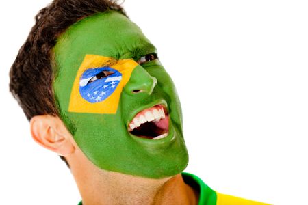 Brazilian man shouting with flag on his face - isolated