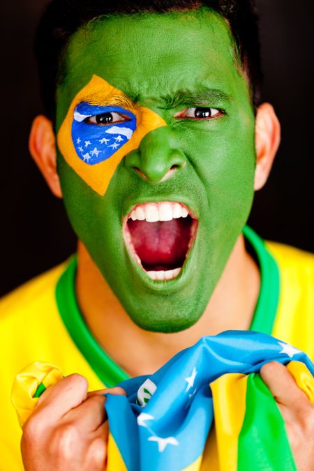 Brazilian man shouting - isolated over a black background
