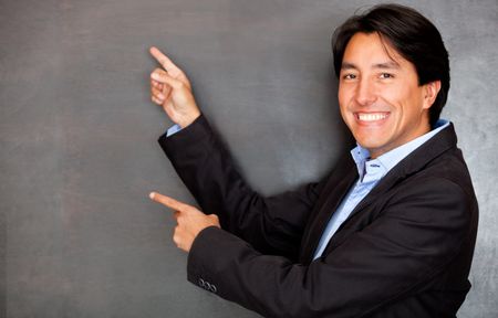 Happy businessman smiling and pointing with both hands