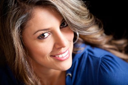 gorgeous-woman-portrait-smiling-isolated-black-100406722 Gorgeous woman portrait smiling - isolated over a black background