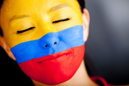 Portrait of a Colombian woman with the flag painted on her face