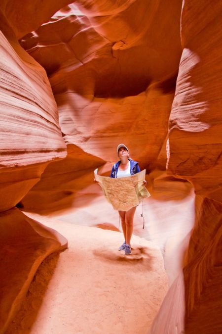 Female tourist exploring the Grand Canyon holding a map
