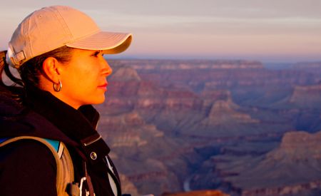 Beautiful woman at the Grand Canyon looking enjoying sunset