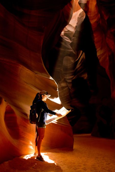 Female explorer inside a cave at the Grand Canyon