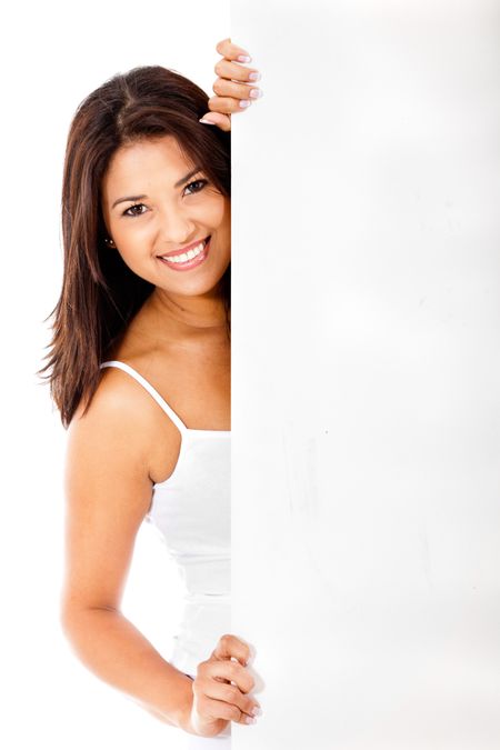 Woman behind a banner ad and smiling - isolated over a white background