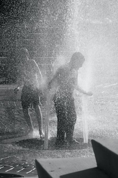 Two boys at play in public geysers