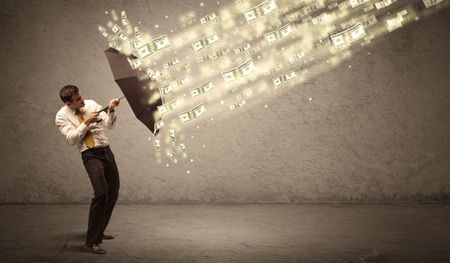 Business man holding umbrella against dollar rain concept on grungy background