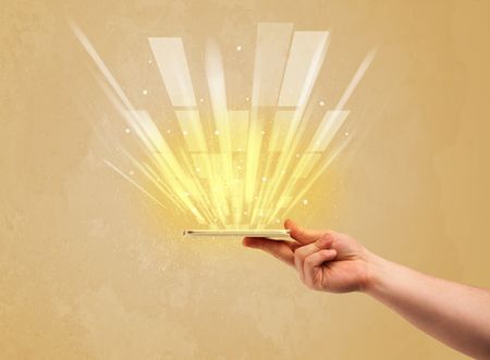 A caucasian hand holding a tablet phone with light beams and information escaping the device illustration concept
