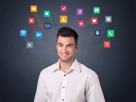 Young casual businessman with colorful applications over his head