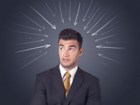 Young businessman with arrows pointing to his head 