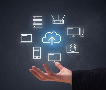 Cloud and computing related icons hovering over young hand