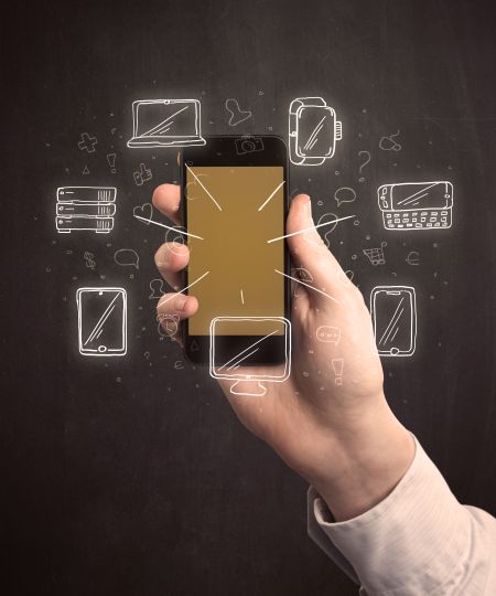 Caucasian hand in business suit holding a smartphone with hand-drawn icons