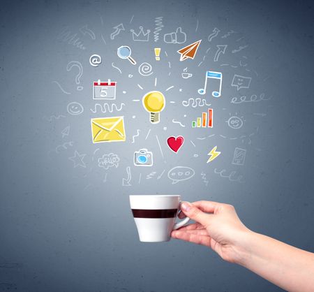 Young female hand holding coffee cup with colorful communication related drawings above it