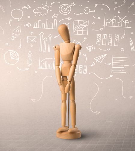 Wooden mannequin posed in front of a greyish background with white scribbled data around him