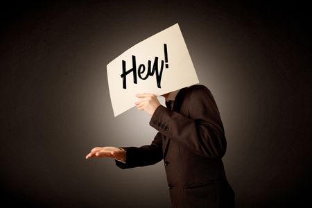 Young businessman hiding behind a greeting drawn on paper