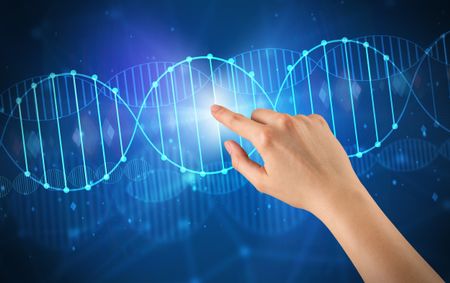 Female hand touching DNA molecule with blue background