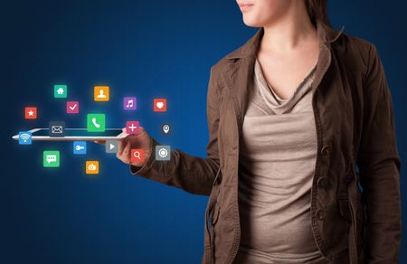 Casual young woman holding tablet with colorful applications 