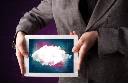 Casual businessman holding tablet with cloud icon and purple background