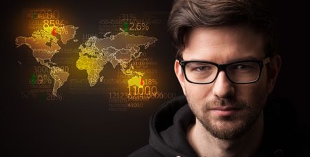 Portrait of a young businessman with a world map and numbers next to him on a dark background