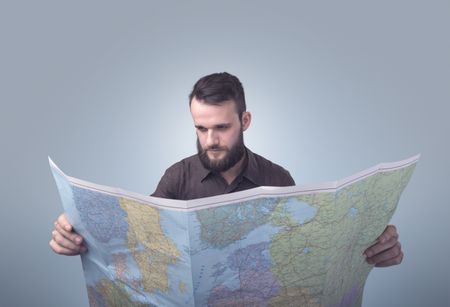 Handsome young man holding map 