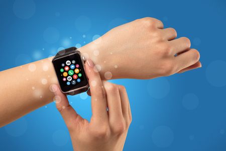 Naked female hand with smartwatch and with application icons on it