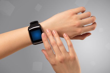 Female hand wearing smartwatch with free space on the screen