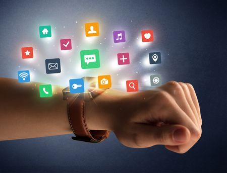 Naked female hand with smartwatch and  application labels around and dark background