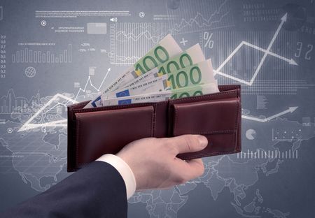 Businessman's hand takes out dollar from wallet with finance graphic on the background