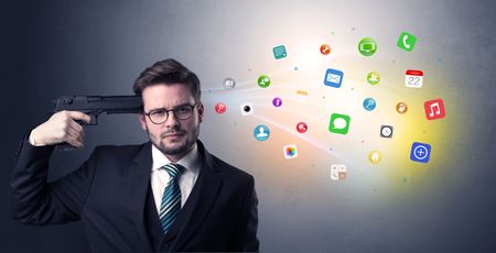 man-shoots-head-gun-application-icons-1007484187 Man shoots his head with gun and application icons coming out from his head