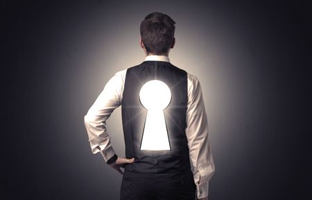 Young businessman standing and thinking with black keyhole on his back