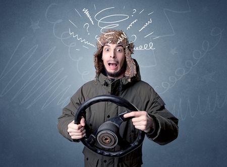 Young man holding black steering wheel with white scribbles around him