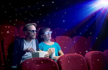 Lovely couple watching 3D movie with little sparkling stars around