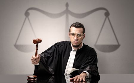 Young handsome judge in black gown making decision