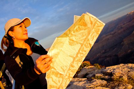 Female explorer with a map at the Grand Canyon