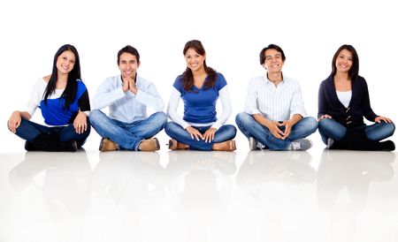 Group of friends sitting on the floor - isolated over a white background