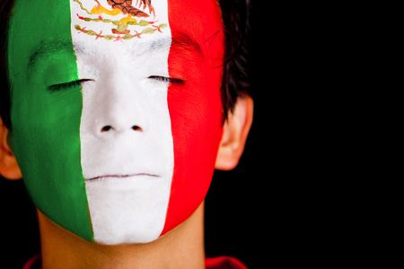 Man with the flag of Mexico painted on his face