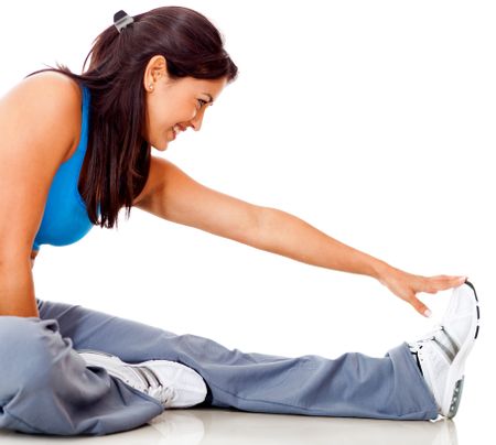 Fit woman stretching her leg - isolated over a white background