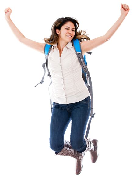 Happy female student jumping - isolated over a white background