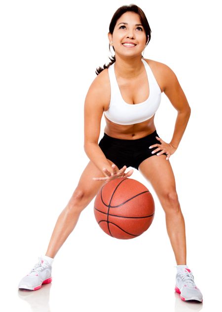 Female basketball player bouncing the ball - isolated over white