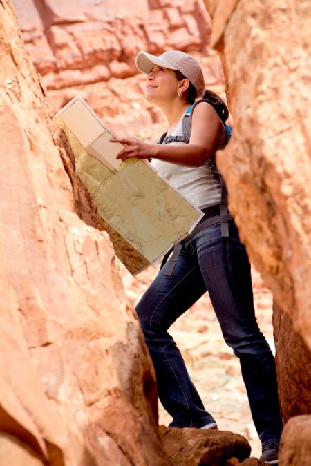 Adventurous woman exploring the desert holding a map