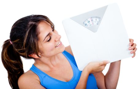 Woman loosing weight holding a scale - isolated over a white background