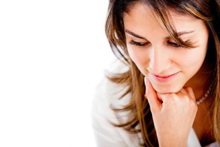 Portrait of a pensive woman looking down - isolated over a white background