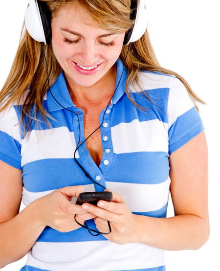 Woman listening to music on her cell phone - isolated over white