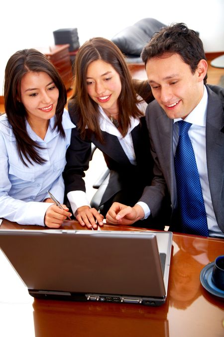 business team during a meeting in an office looking at a laptop computer