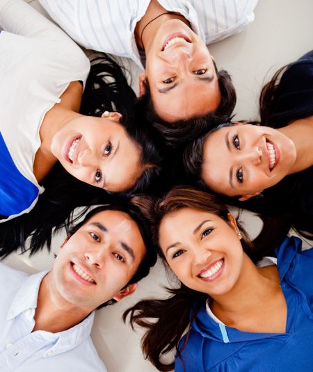 Happy group of friends lying on the floor together