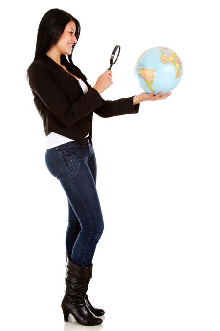 Woman looking at the globe with a magnifying glass - isolated