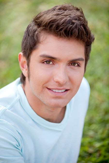 Portrait of a casual man smiling outdoors